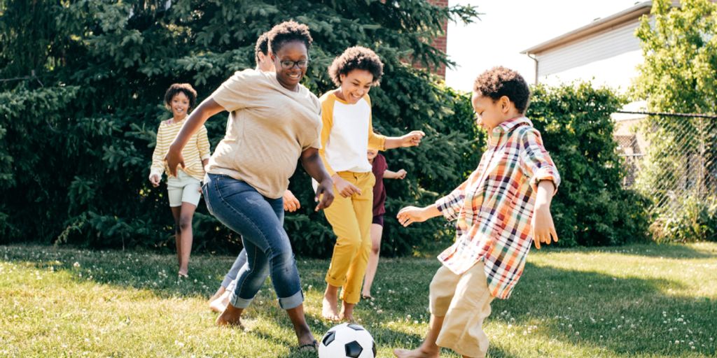 happy family playing together in a park