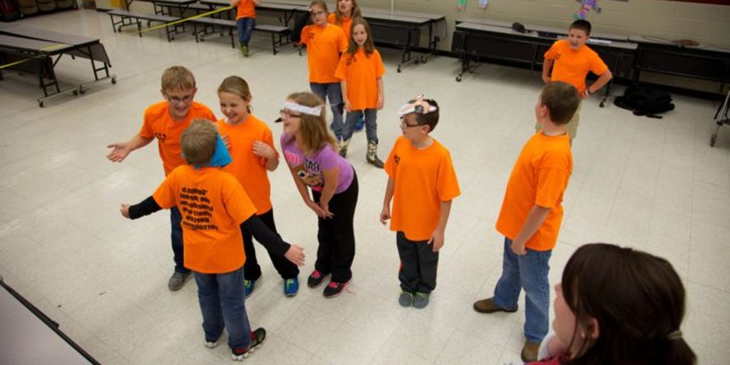 children playing educational games in kindergarten classroom