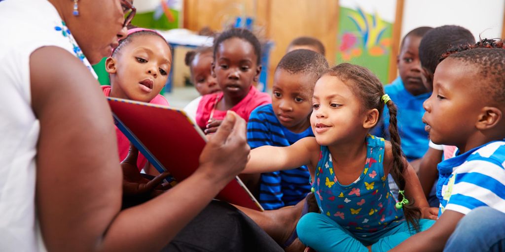 children playing educational games in a colorful classroom